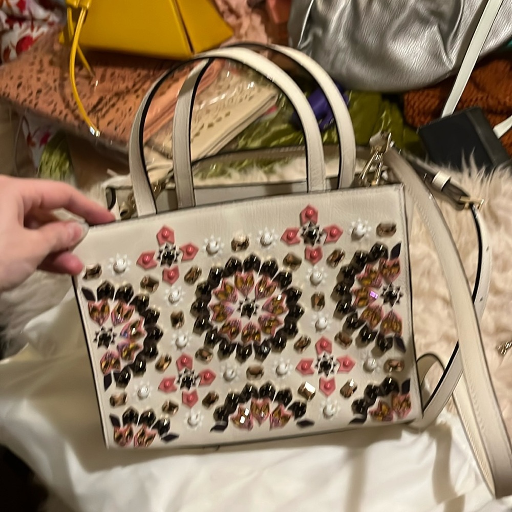 NWOT KSnever used, no flaws, cream with multi colored jewels, cat friendly home.